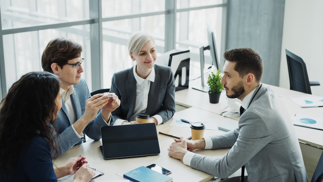 🎬 FULL 4K VIDEO for this still is in my bio link! ⬇️Businessman discussing future business project with male and female colleagues sitting at the table in modern office indoors